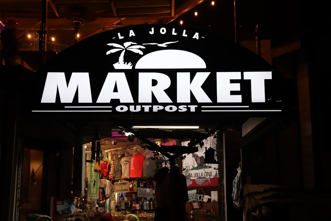 a-sign-that-says-market-outpost-in-front-of-a-store-y5-qshgifjs